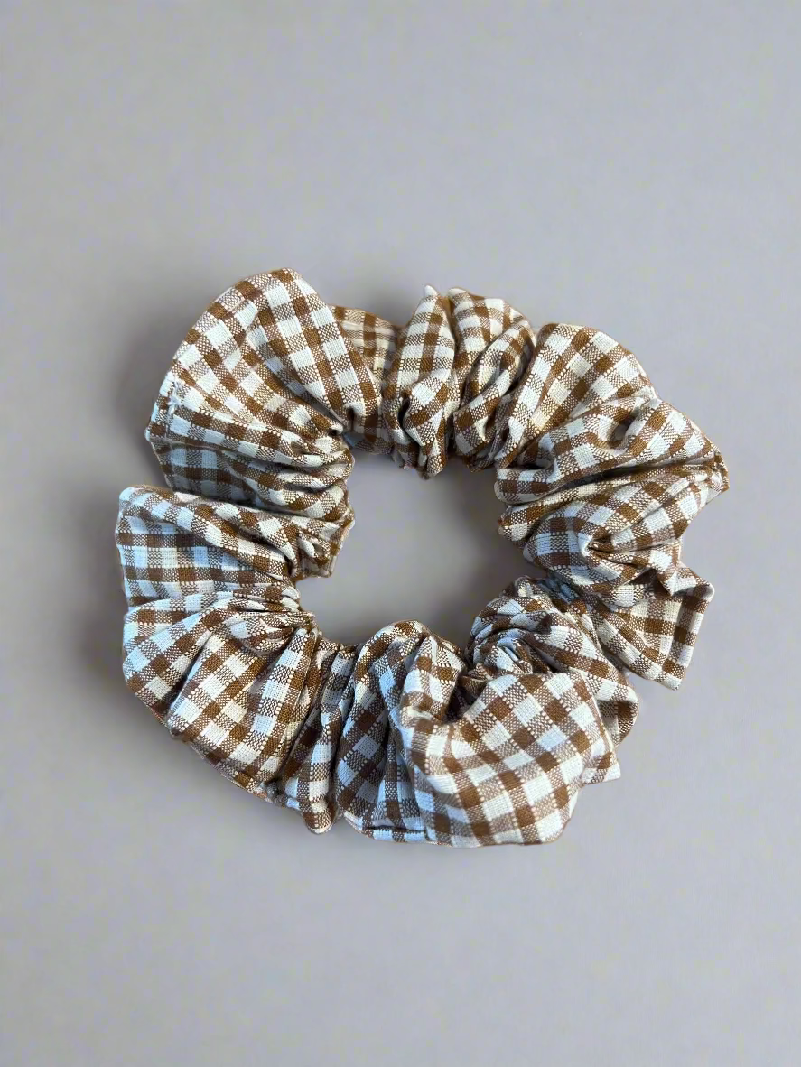 Brown and white checkered scrunchie on a white surface