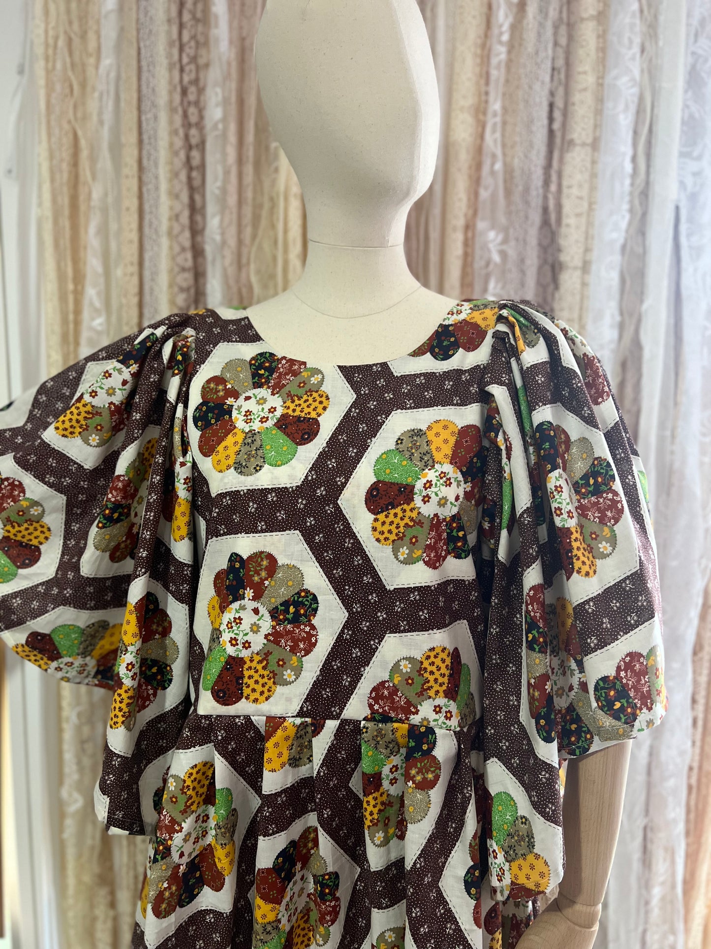 Mannequin wearing a dress with a colorful geometric pattern against a neutral background