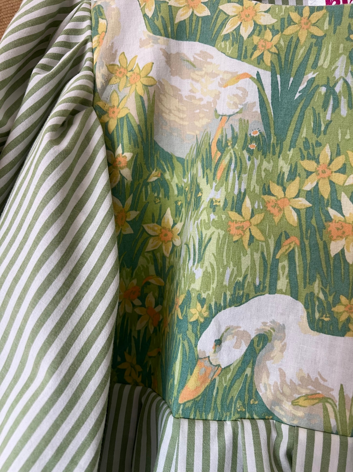 Fabric with goose and floral pattern next to striped fabric