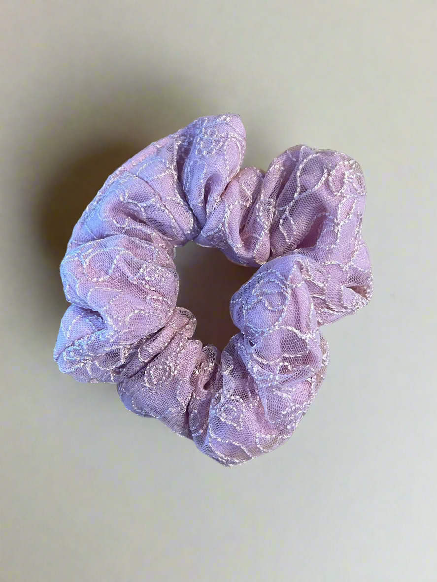 Pink scrunchie on a white surface