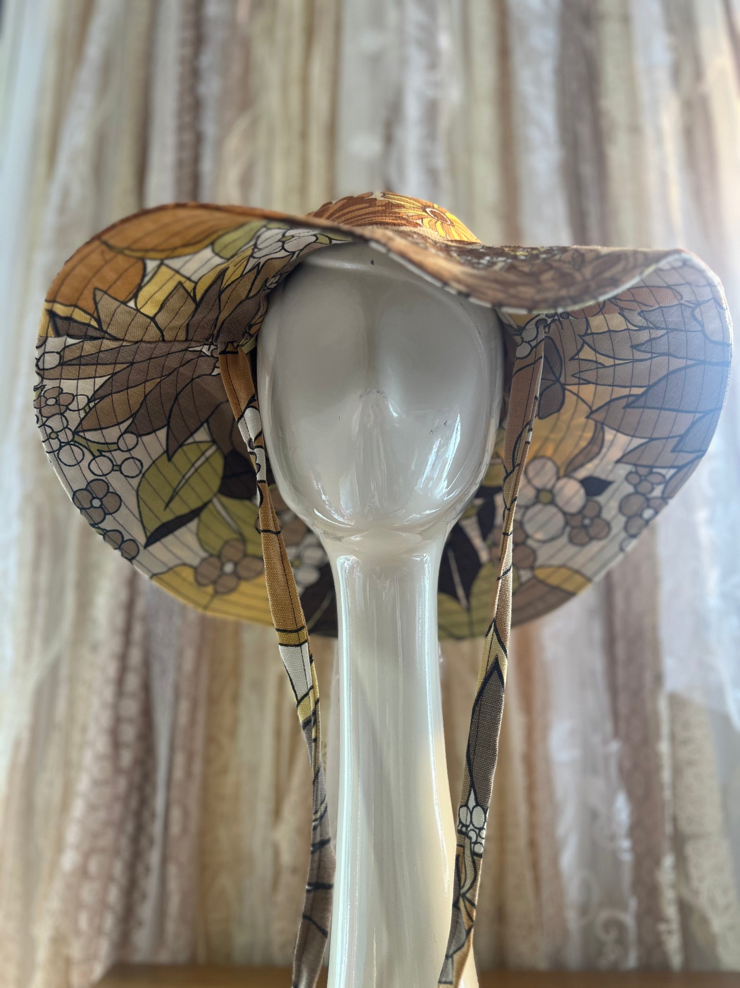 Decorative hat with a floral-pattern against a neutral background