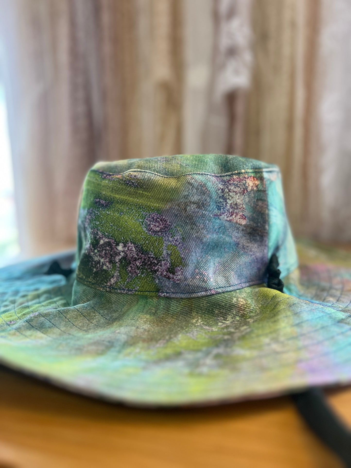 Colorful bucket hat on a wooden surface with a neutral background