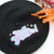 Black felt wool beret with an embroidered 'Hell Yeah' slogan in pink and blue to the top