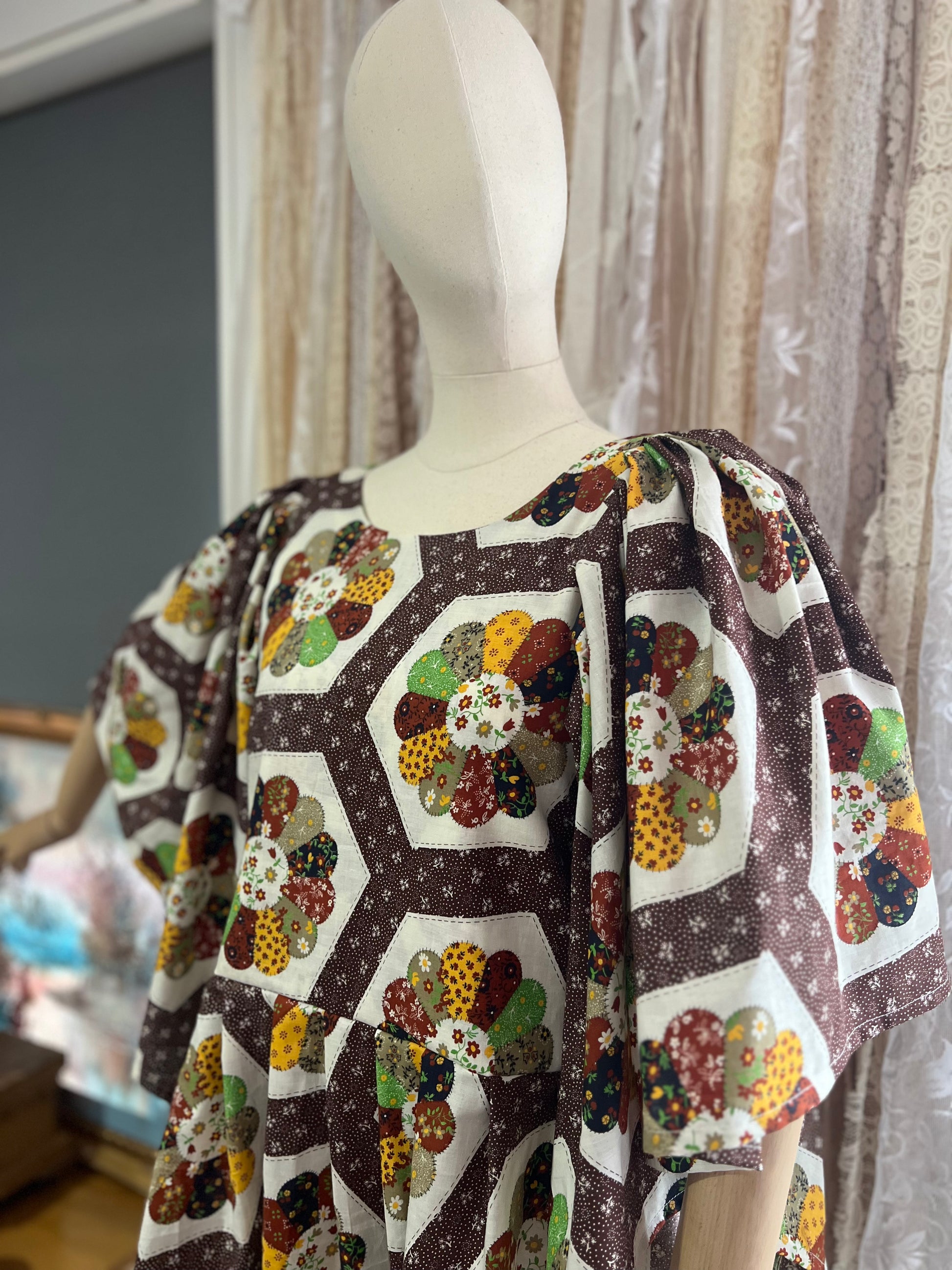 Mannequin wearing a quilt print dress with a geometric pattern in a home setting