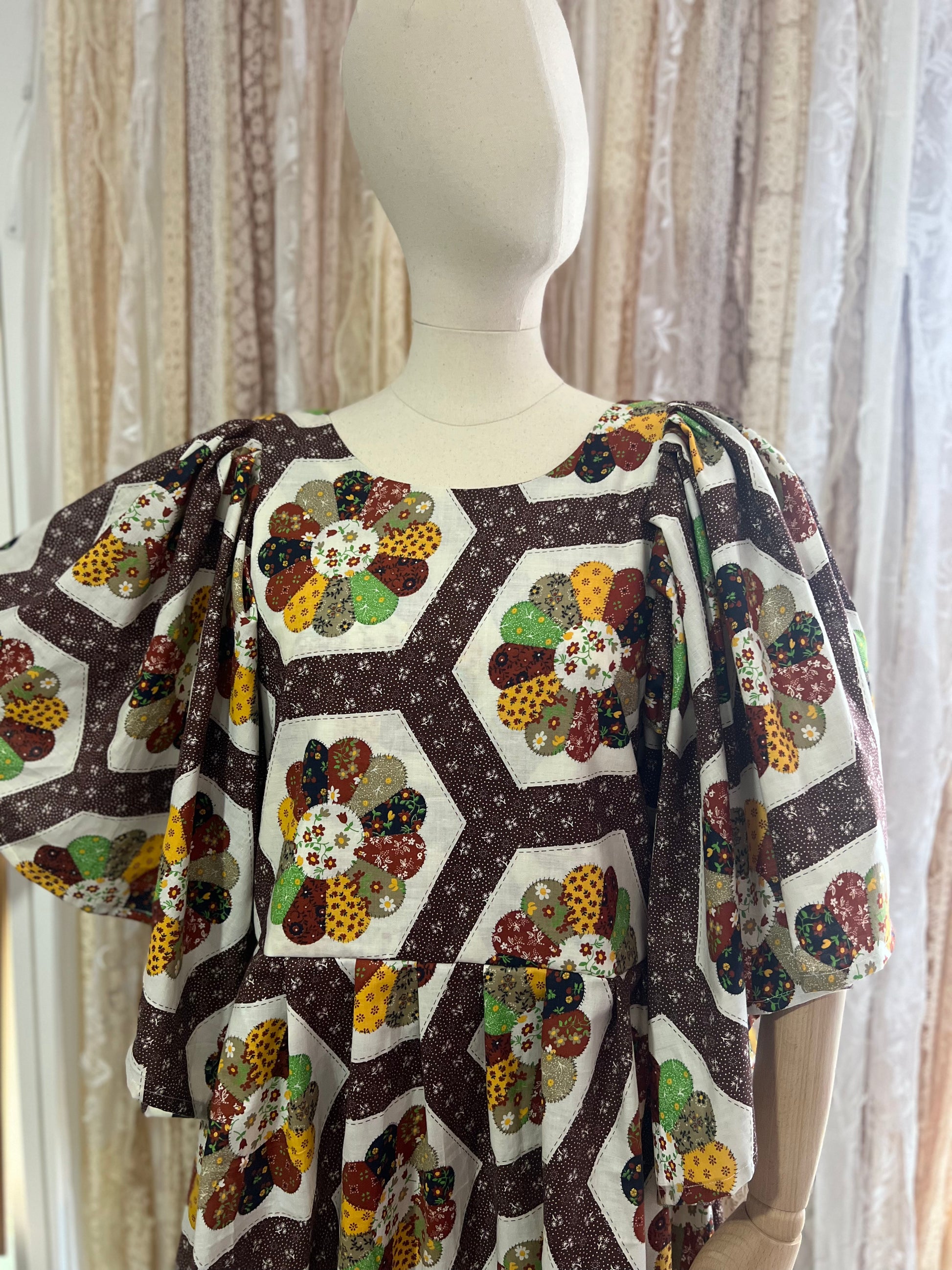 Mannequin wearing a dress with a colorful geometric pattern against a neutral background