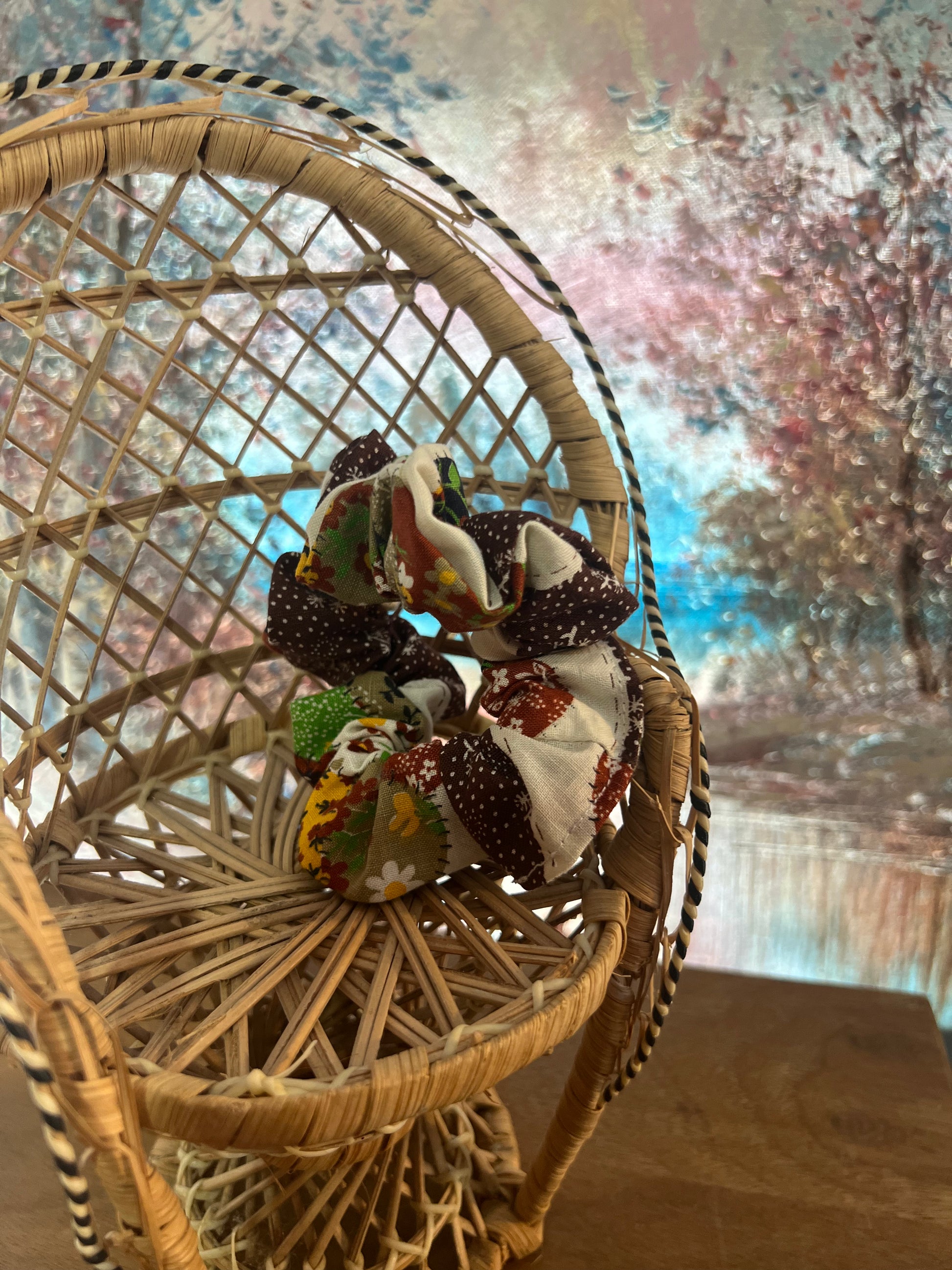 Decorative scrunchie on a wicker chair against a blurred outdoor background