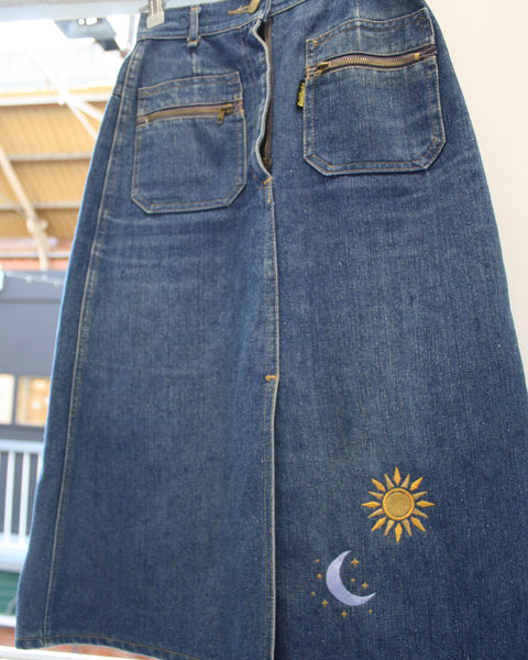 Embroidered patch vintage denim skirt. Embroidered to front with a sun and moon design, and to the back with some gorgeous cowboy boots. Made from a vintage denim skirt found in a charity shop.