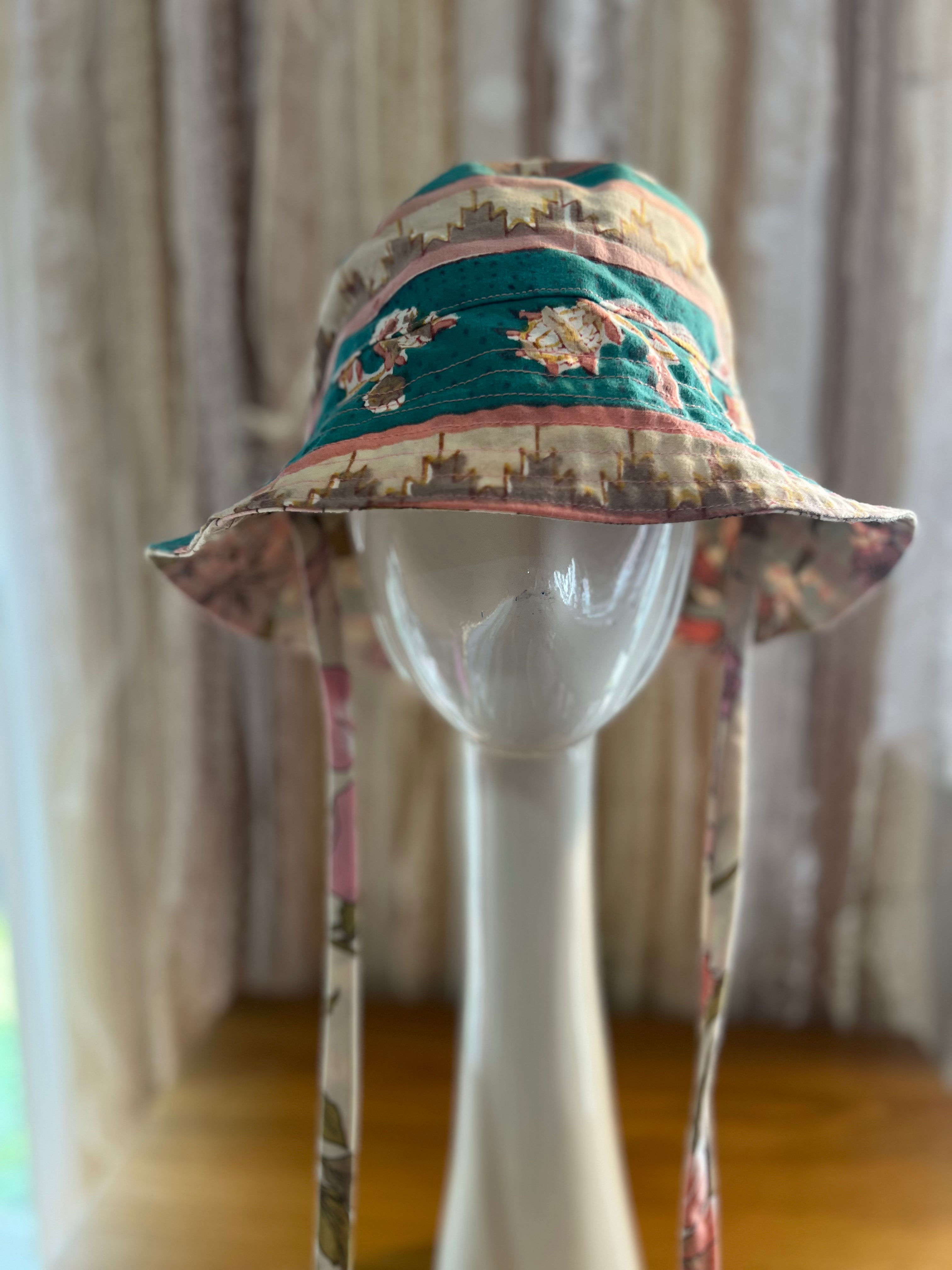 Colorful bucket hat on a mannequin head with a neutral background