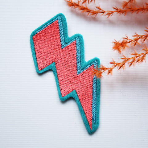 Lightning bolt embroidered iron on patch. She has iron on transfer attached to the back, which can be ironed on to your desired item of clothing.