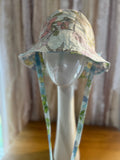Floral-patterned bucket hat on a mannequin head against a neutral background