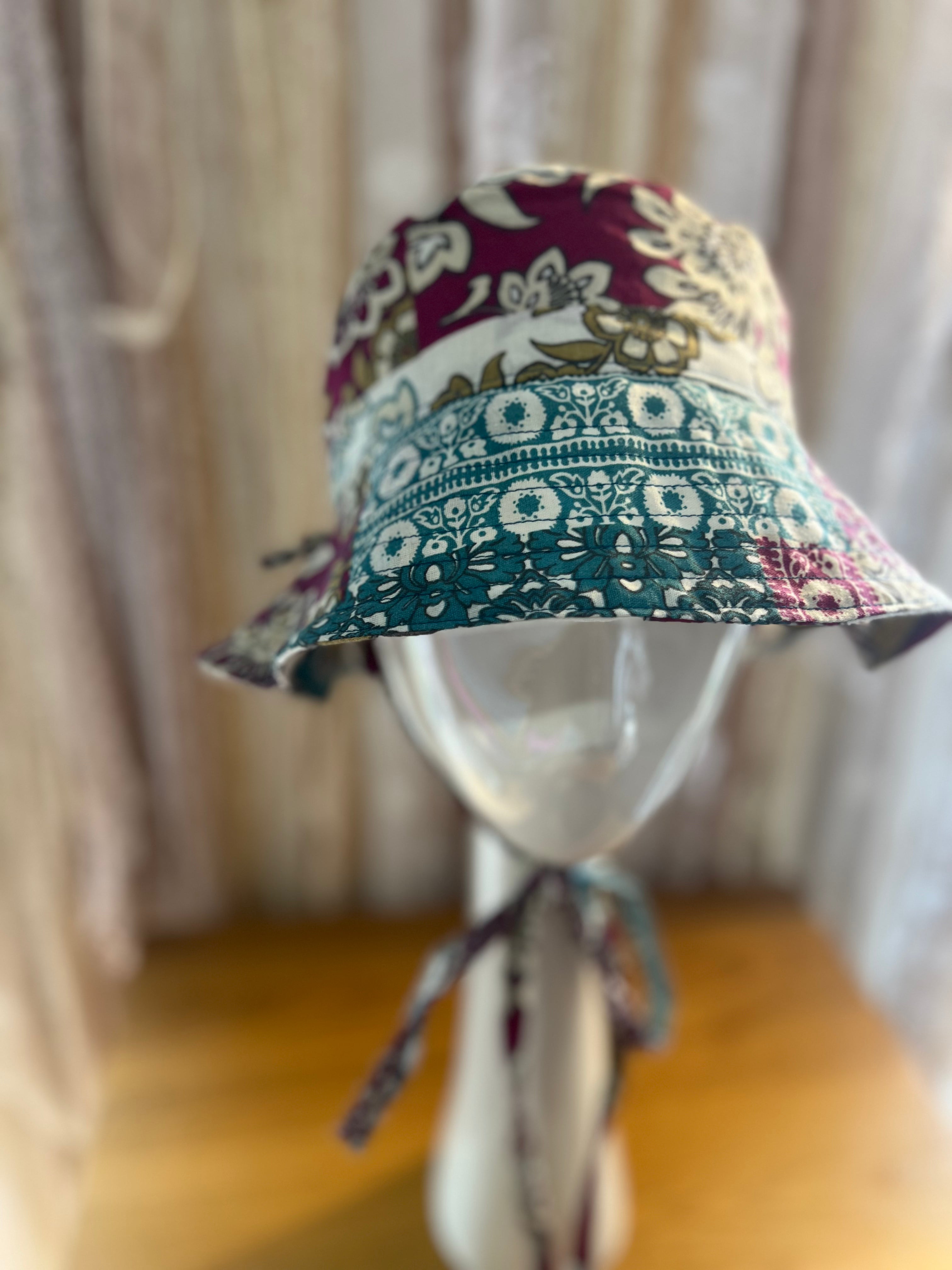 Colorful patterned bucket hat on a mannequin against a neutral background