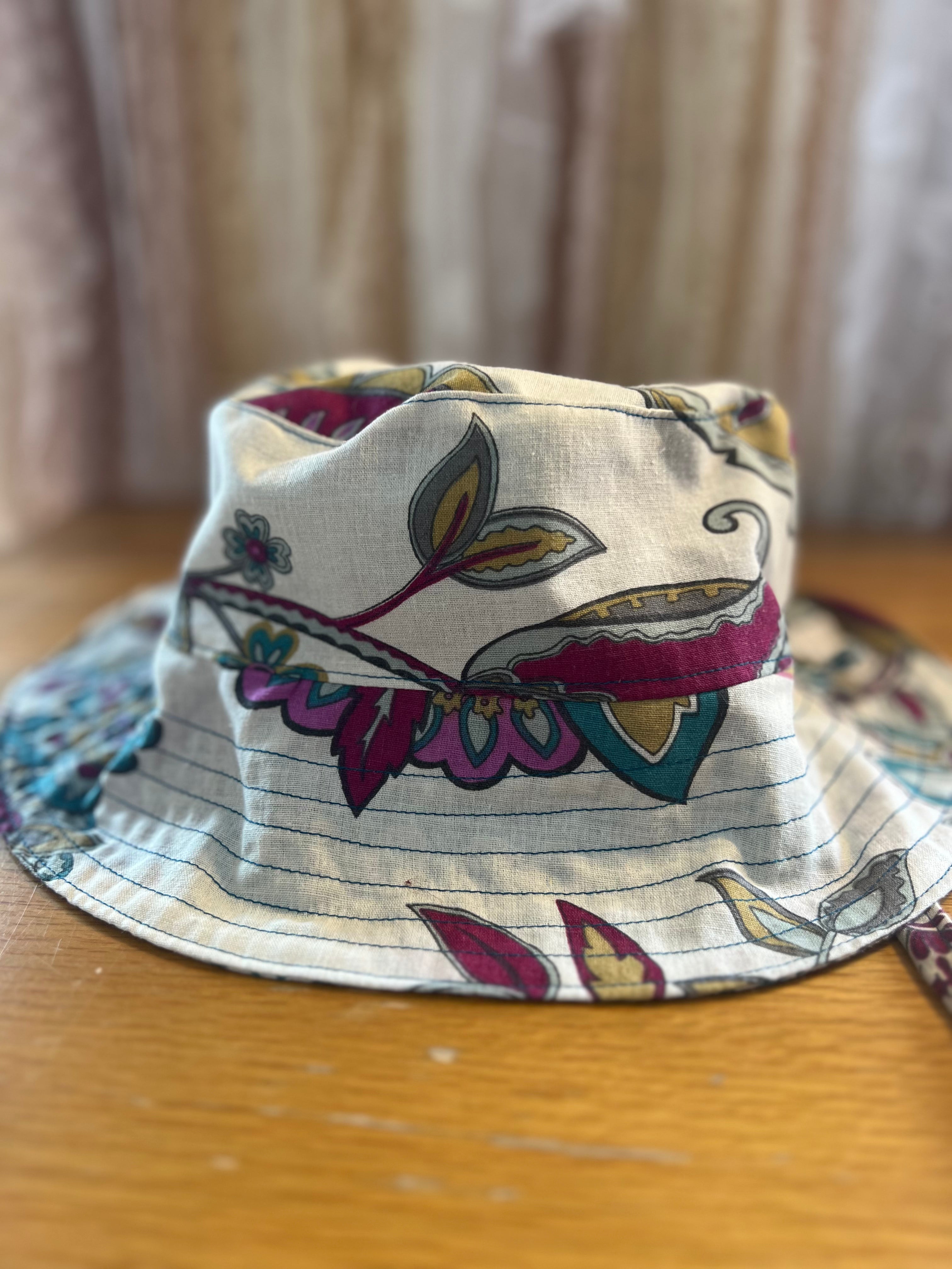 Bucket hat with floral pattern on a wooden surface