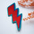 Lightning bolt embroidered iron on patch. She has iron on transfer attached to the back, which can be ironed on to your desired item of clothing.