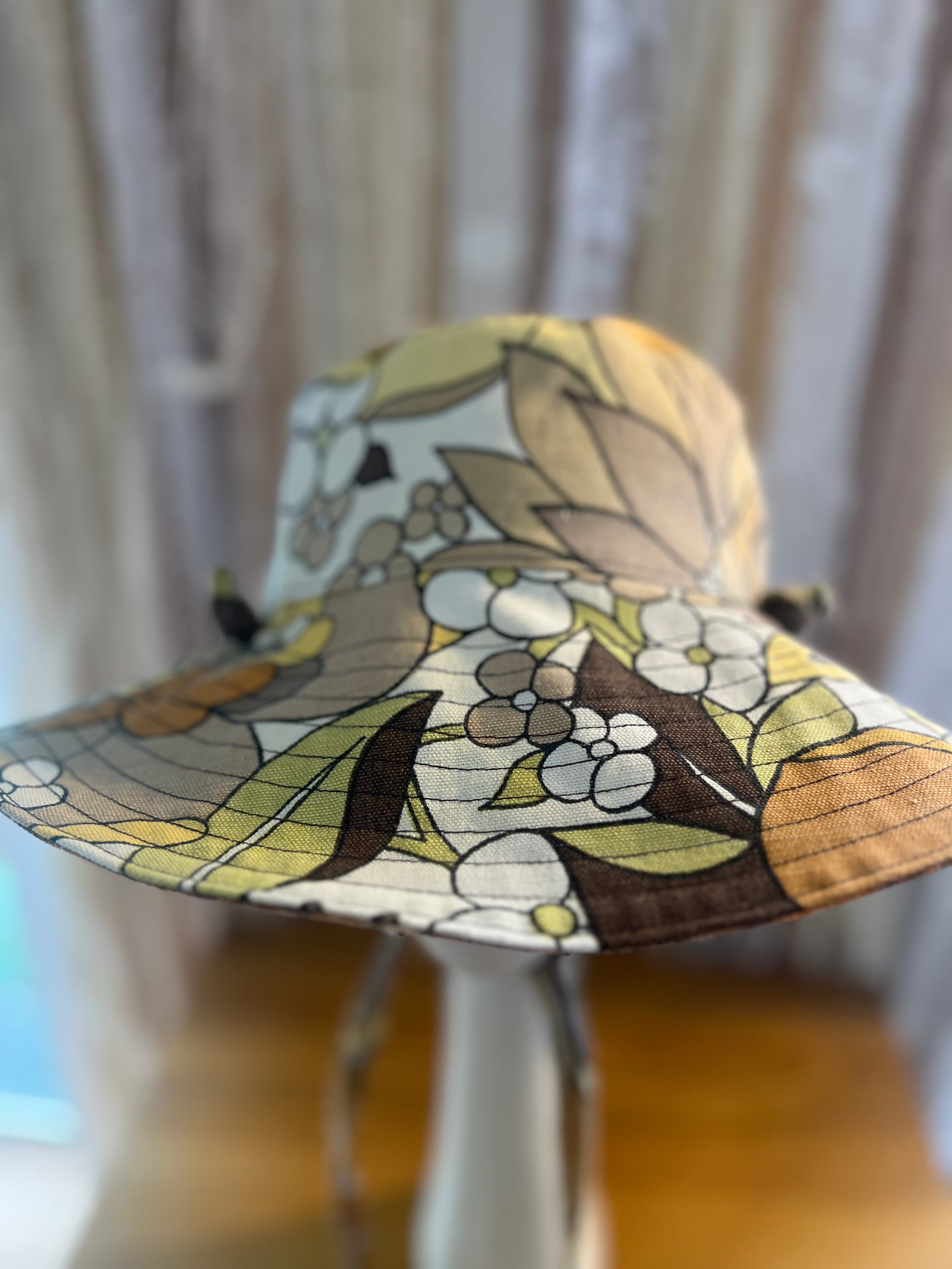 Floral patterned sun hat on a chair with a blurred background