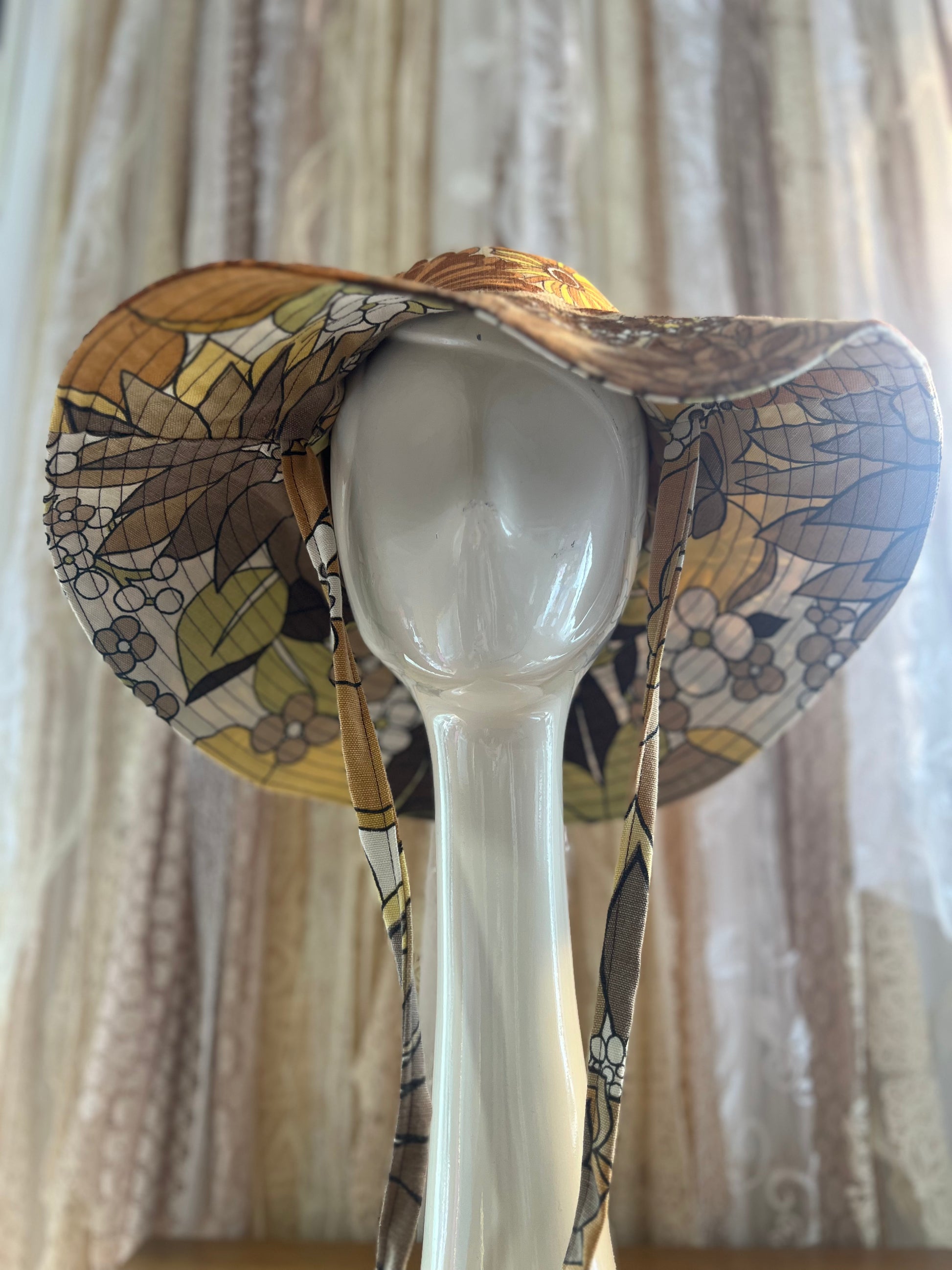 Decorative hat with a floral-pattern against a neutral background